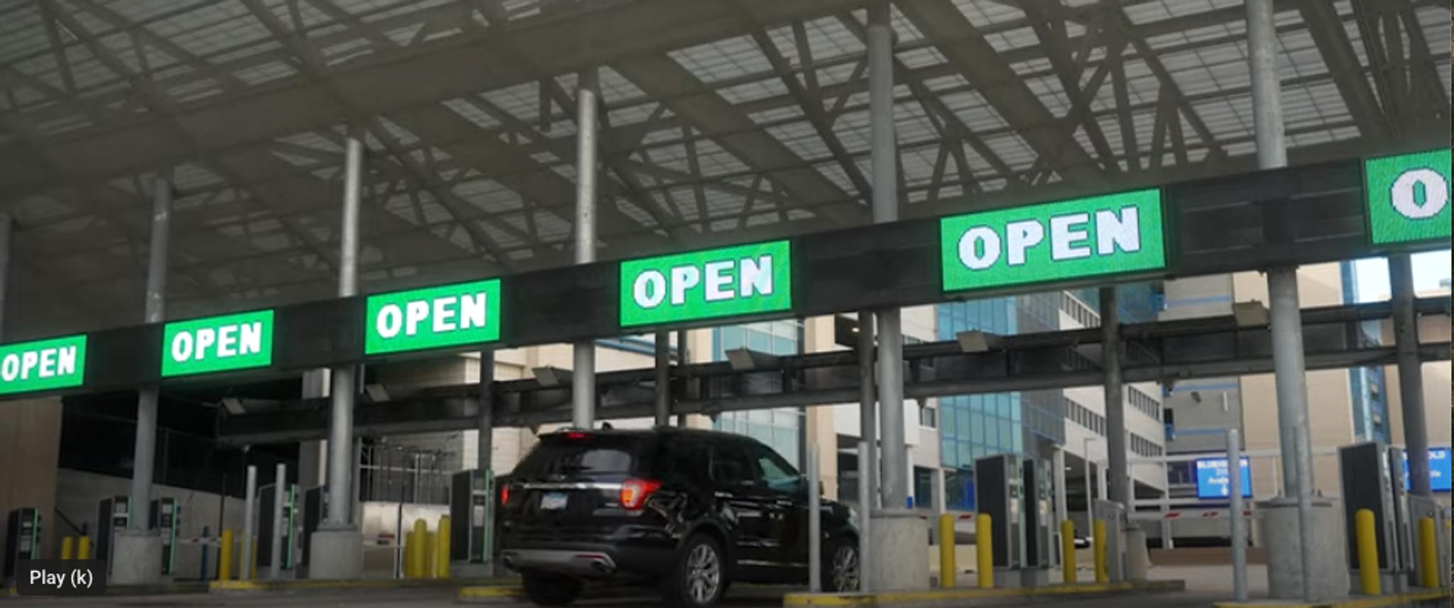 Car-approaches-airport-parking-gate