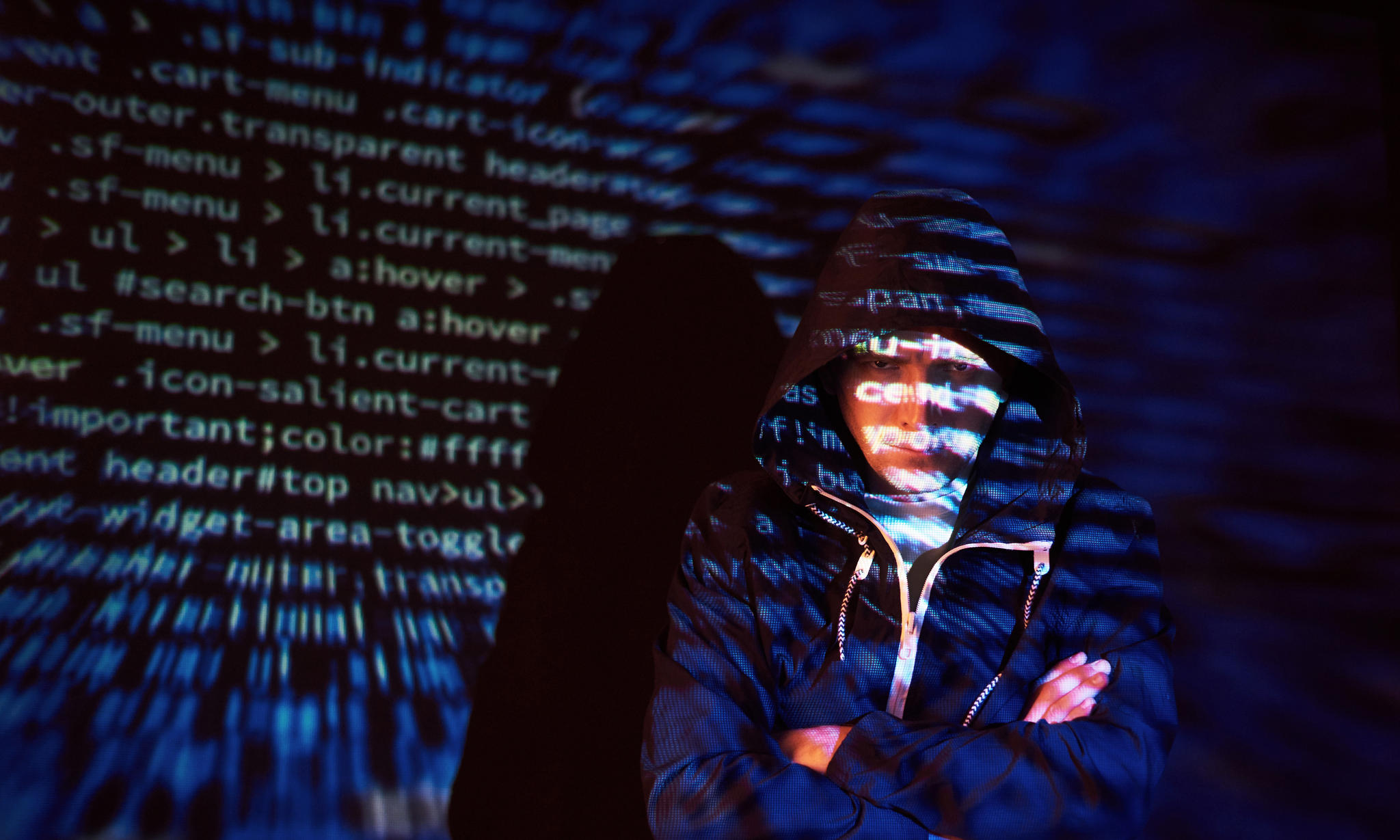 Cyber attack with unrecognizable hooded hacker using virtual reality