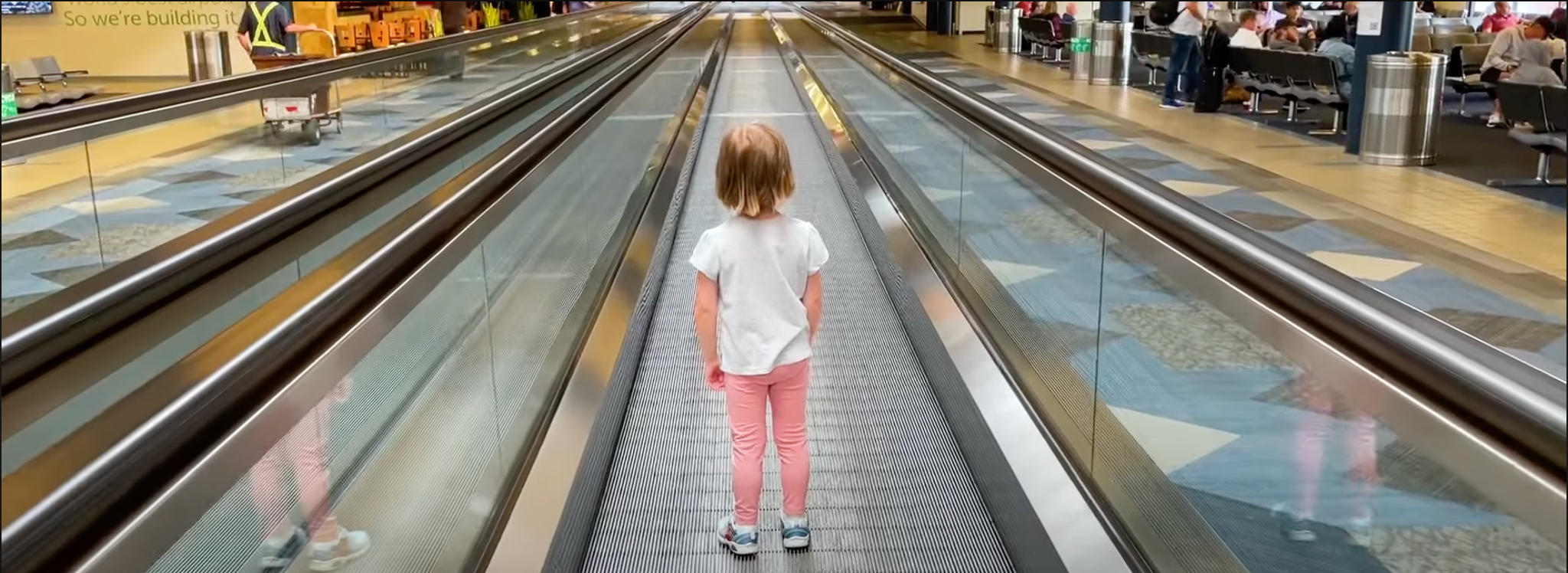 child-on-people-mover-during-layover-airport