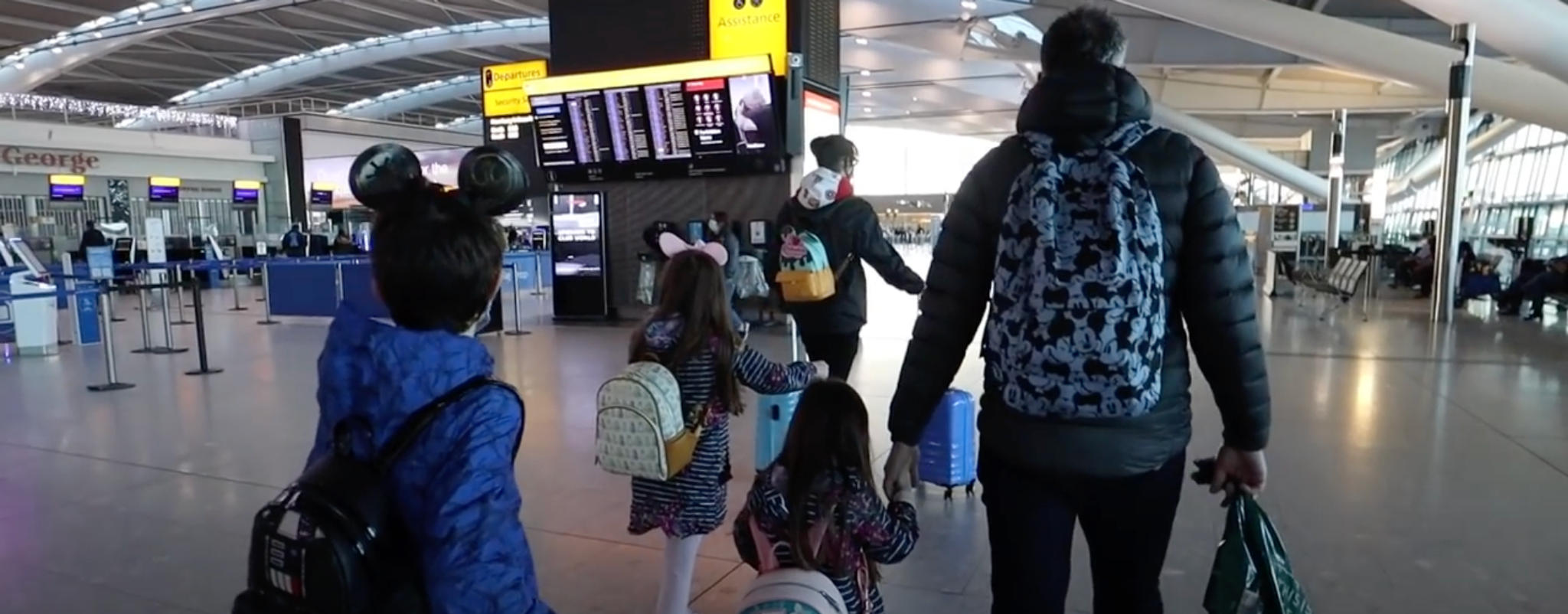 family-with-children-walking-airport-terminal