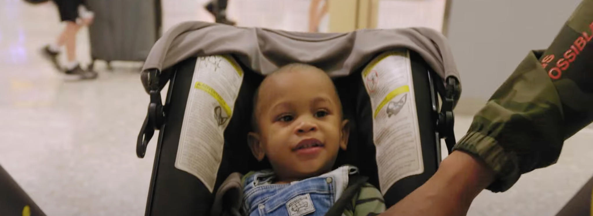 infant-sits-in-car-seat-airport-terminal