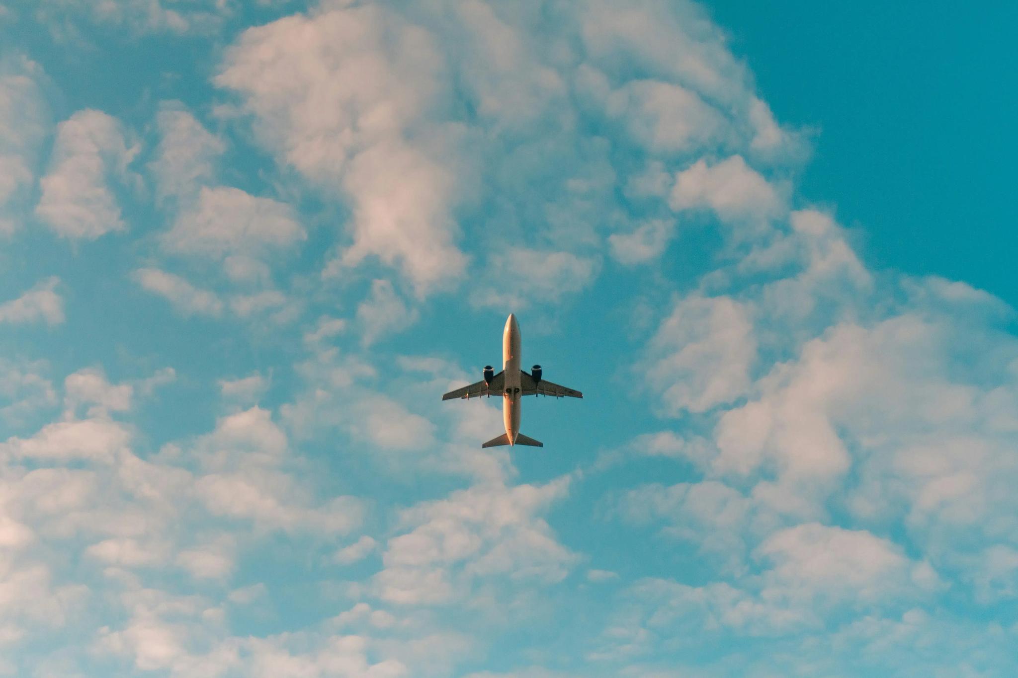 underside of airline jet flying