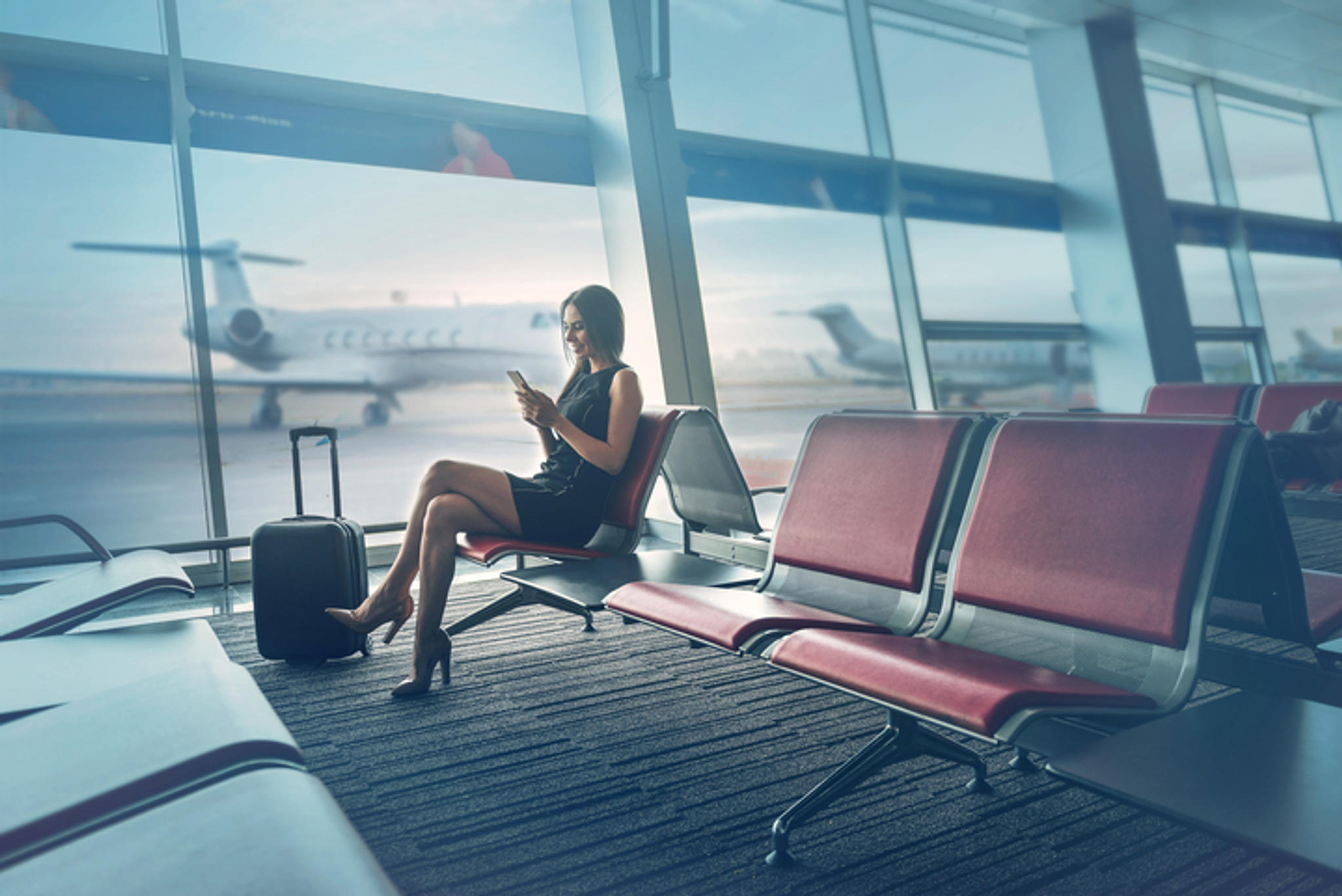 woman sitting at departure gates