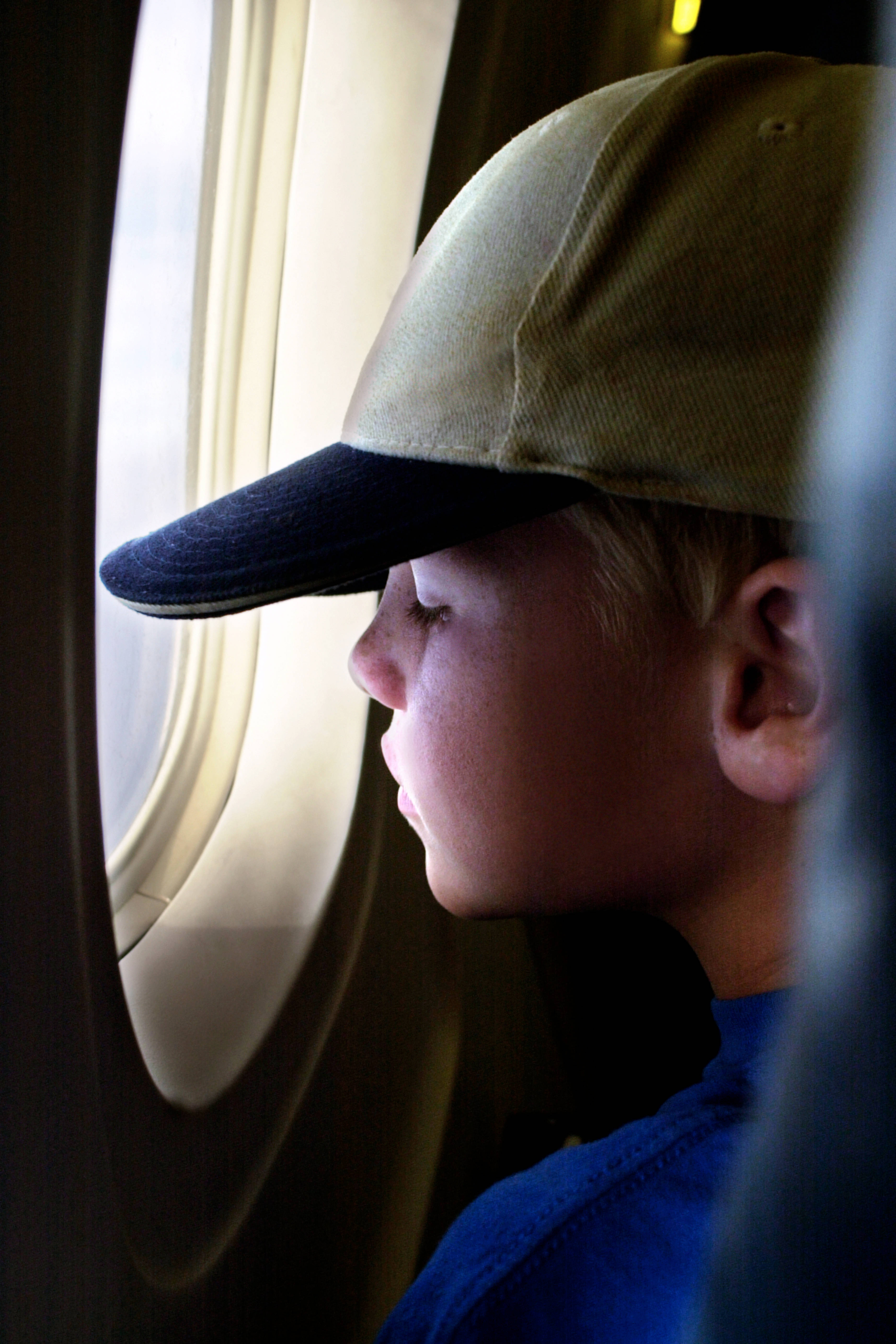 Boy looking out airplane window