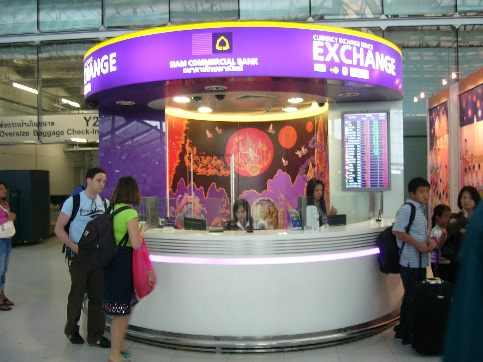 Currency exchange counter with various international currencies displayed