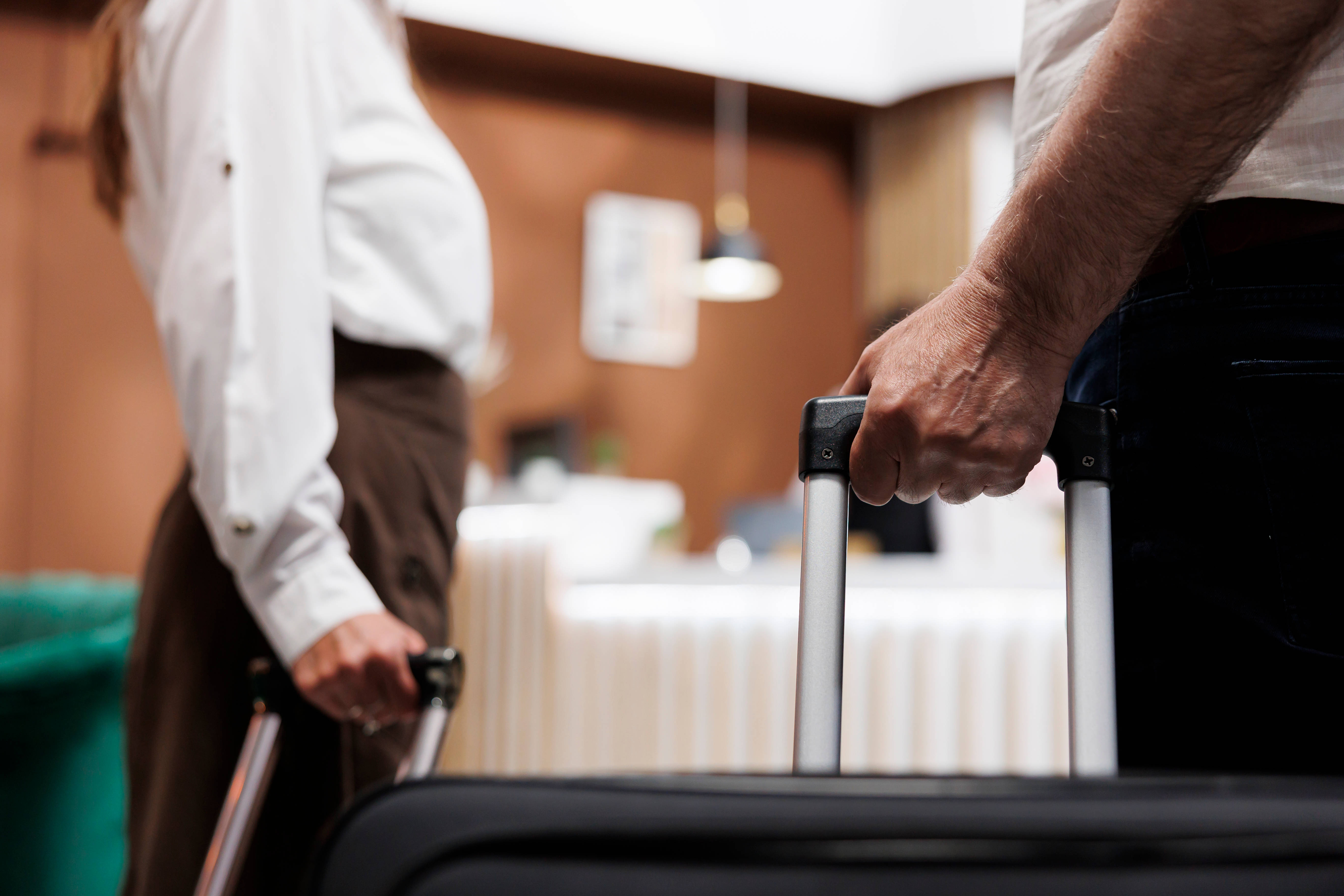 Guests with suitcases checking in at hotel reception desk