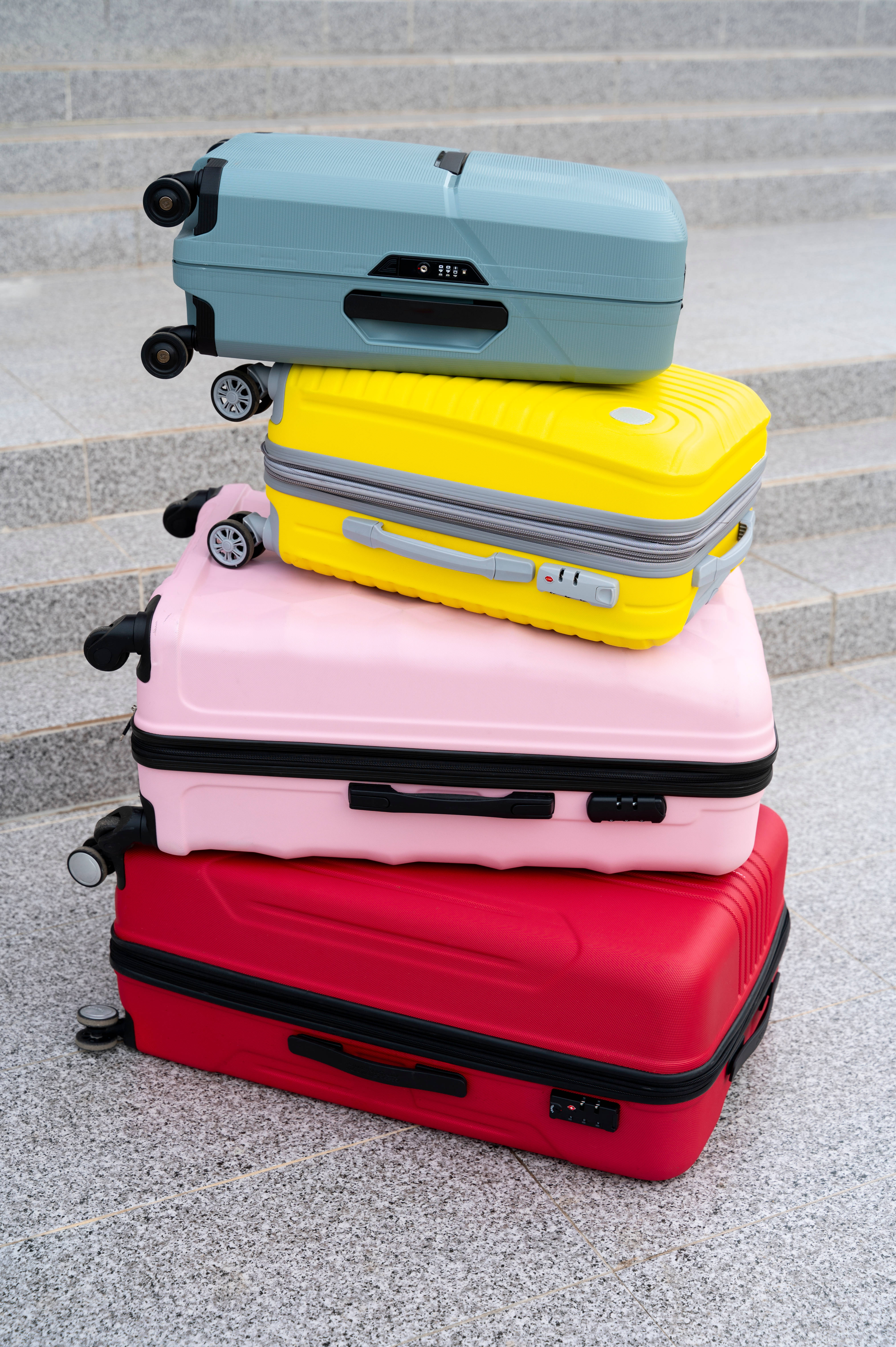 Suitcase with wheels standing outdoors on a paved surface