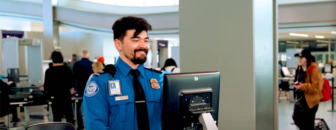 TSA-officer-smiling-at-security-checkpoint
