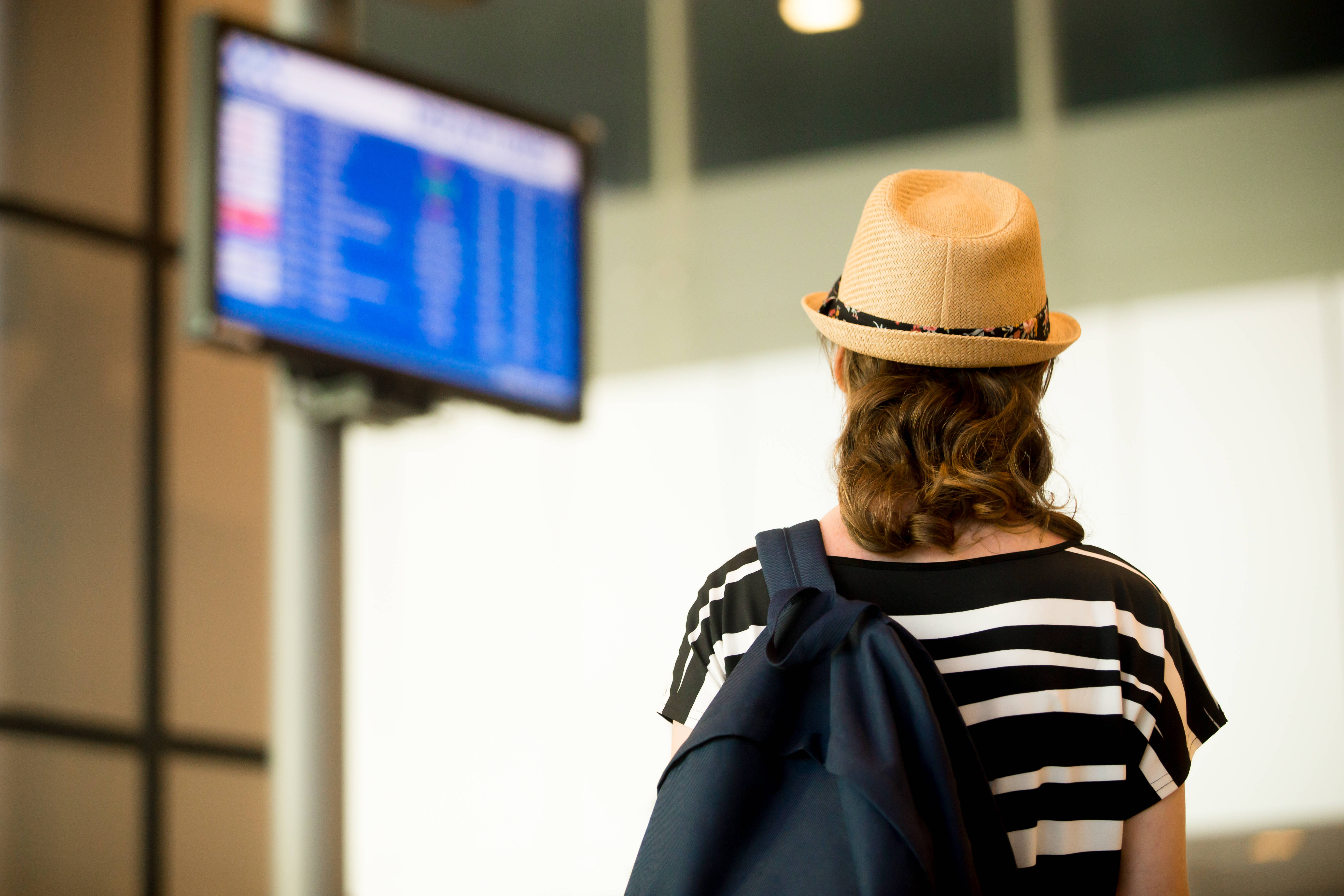 Woman looking screens at the airport