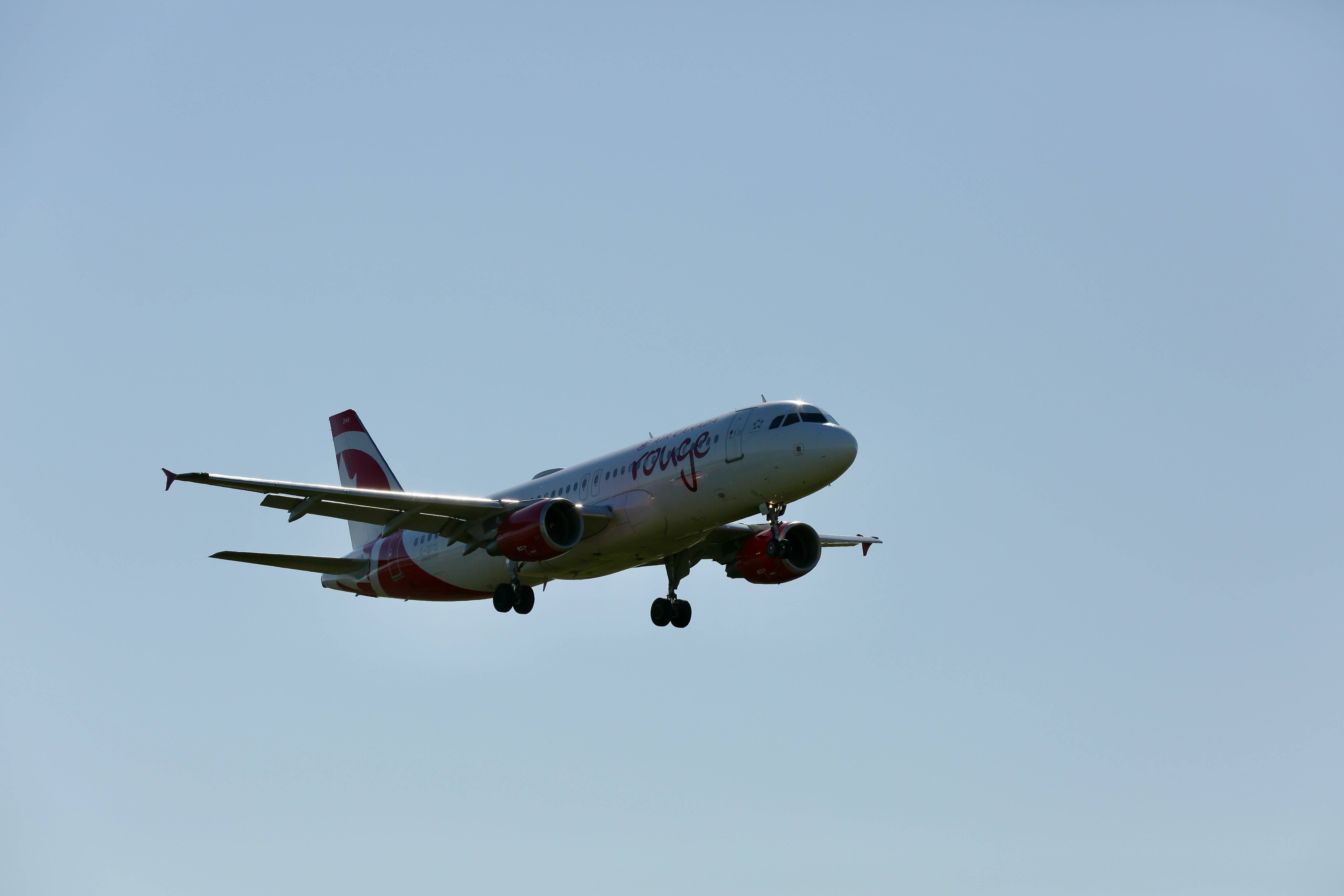 A large jetliner flying through a clear blue sky