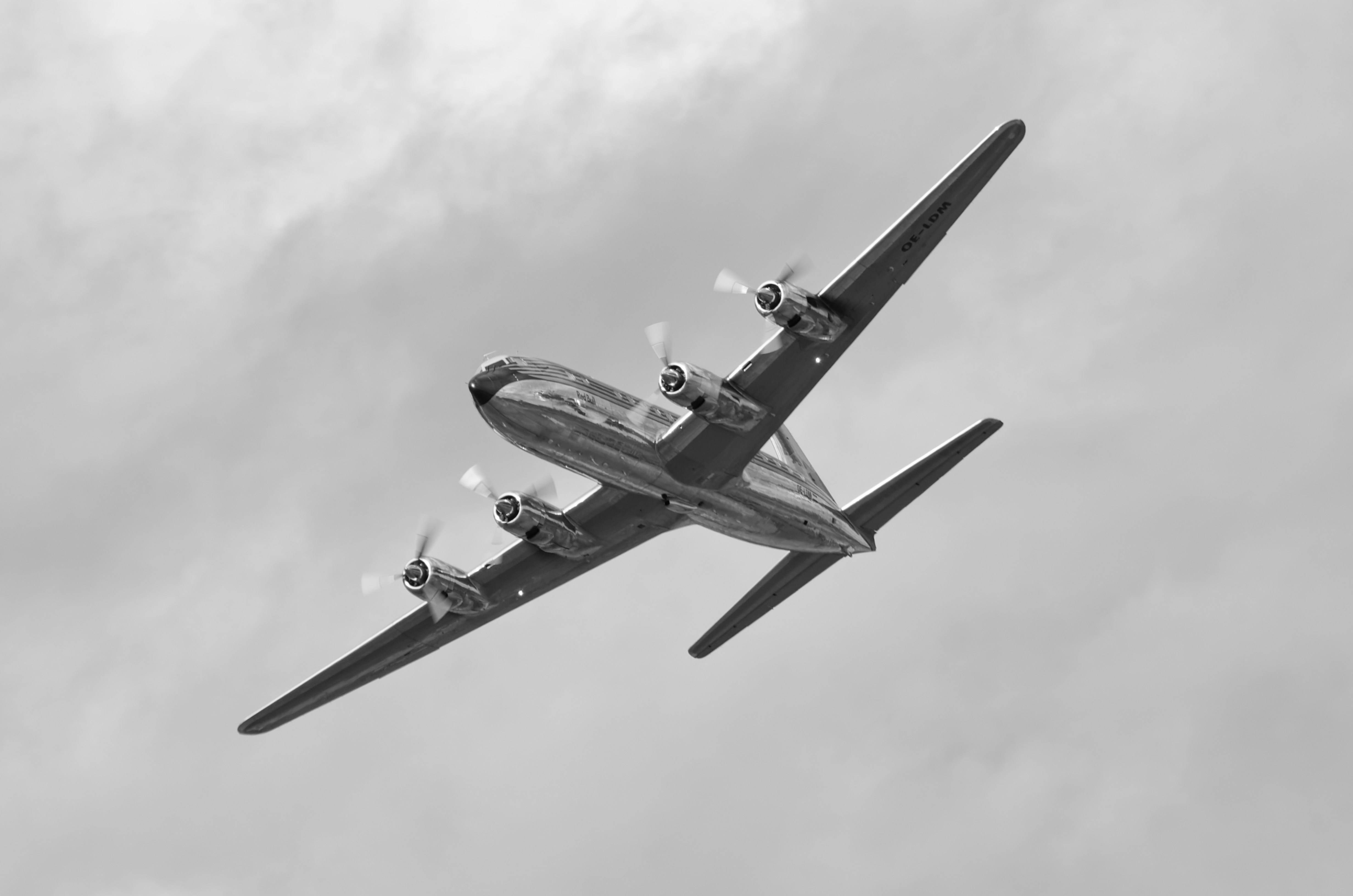 a propeller plane flying through a cloudy sky