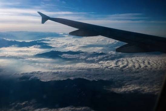 airplane flying over clouds