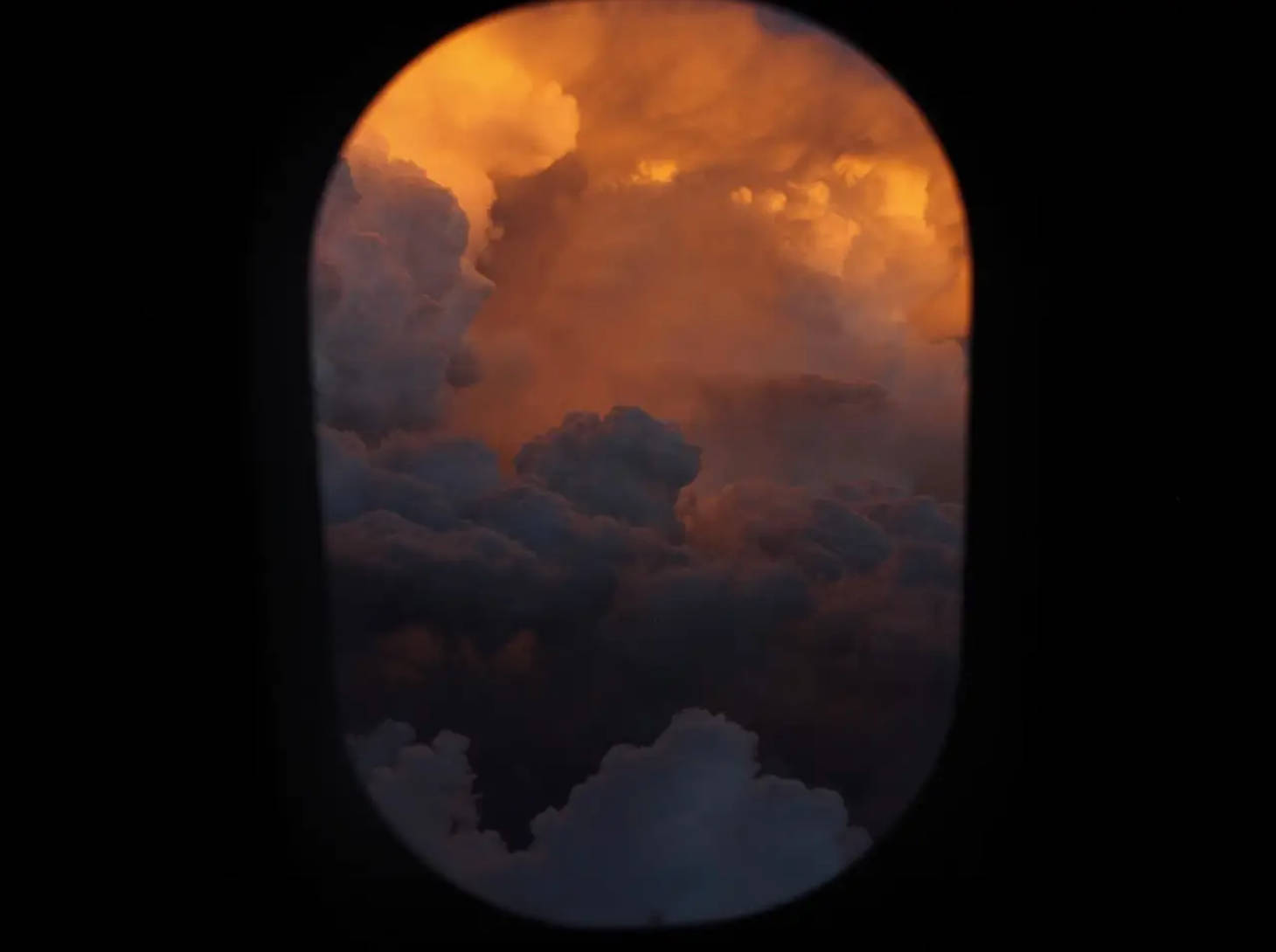 view from airplane window shows storm clouds