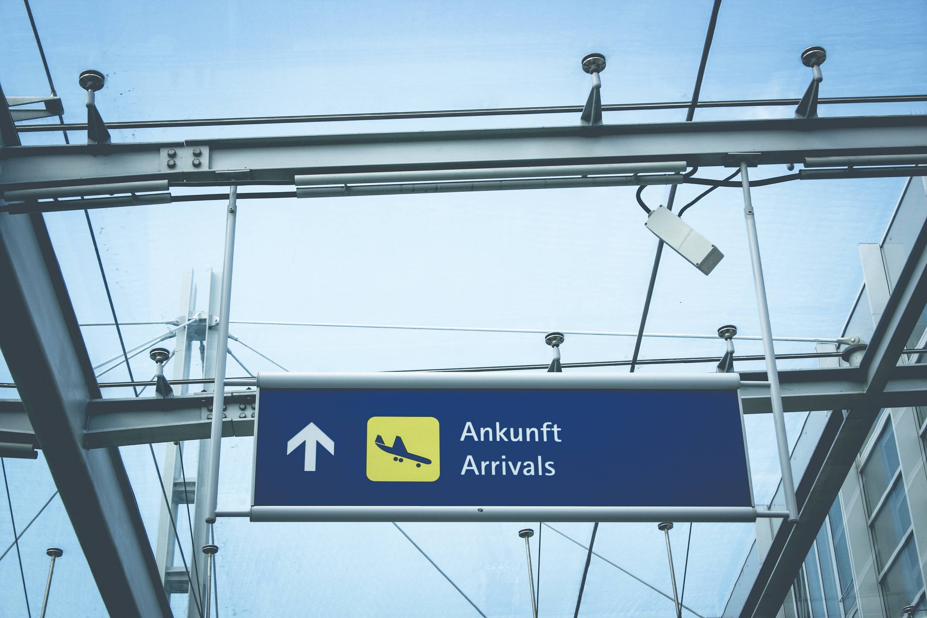 Passengers arriving at an airport, walking through the terminal with luggage