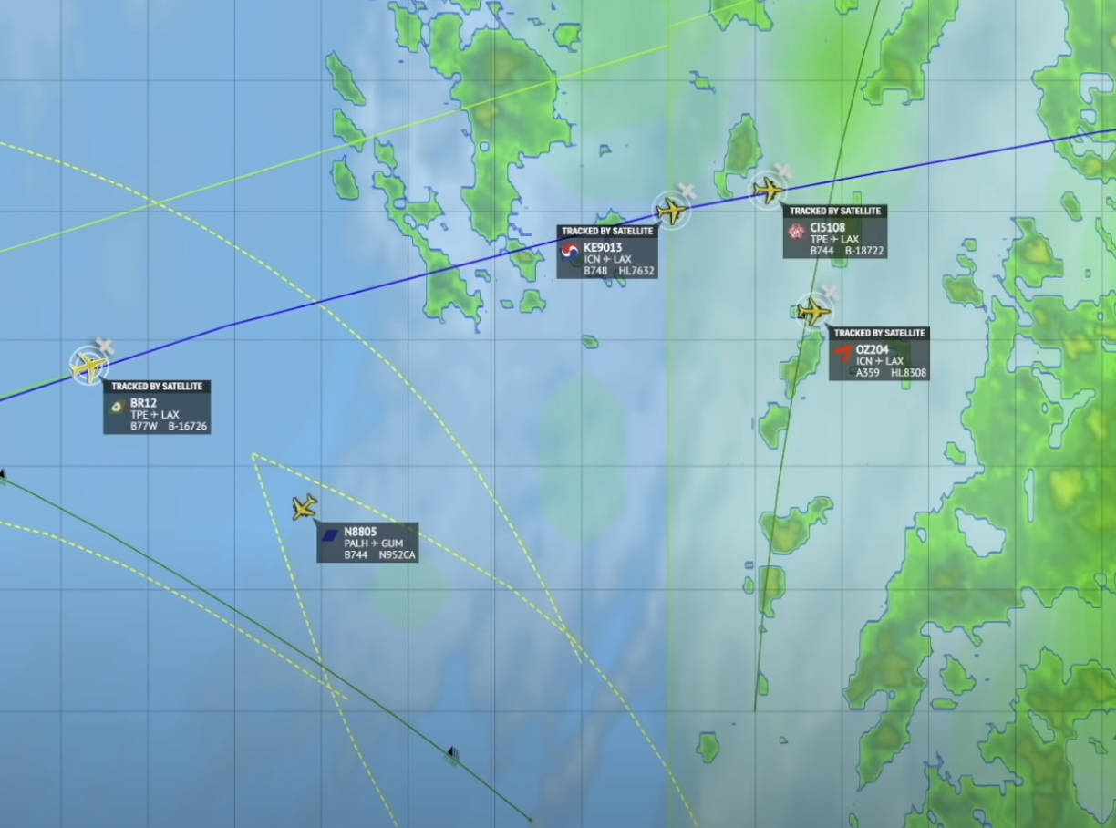 Tracking multiple flights over the Pacific Ocean, with flight paths and aircraft icons displayed on a digital map