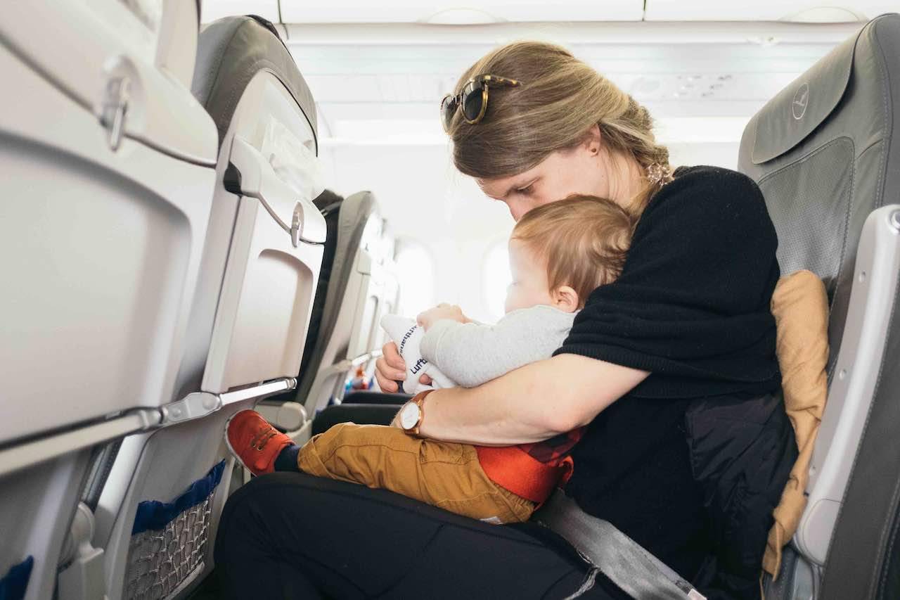 Infant on lap in aircraft 