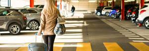 traveler walking to airport parking lot