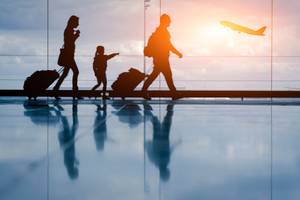 family walking through airport terminal